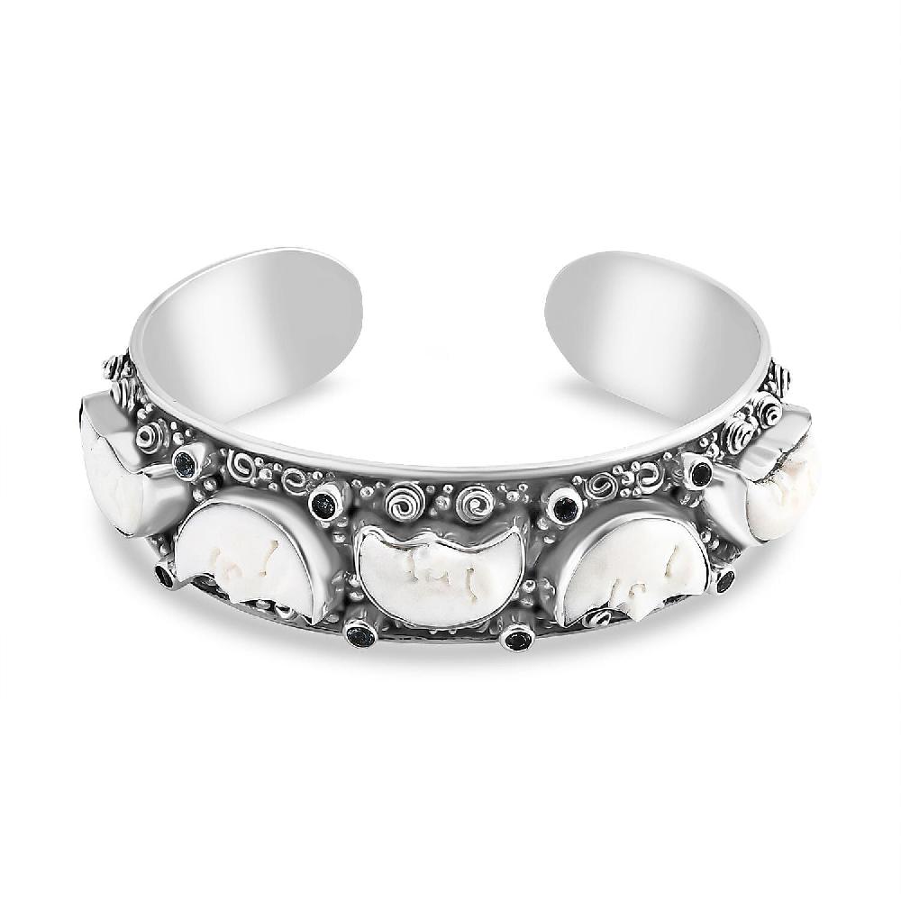 Bali Legacy Carved Bone and Blue Topaz 1.20 ctw Moon Cuff Bracelet in Sterling Silver (8.00In)