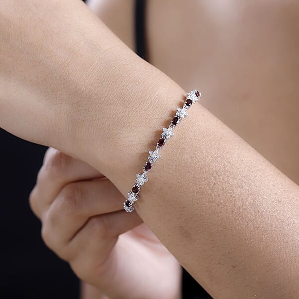 D'Joy Premium Anthill Garnet And Moissanite 5.30 Ctw Flower Bracelet In Rhodium Over Sterling Silver (7.25 In)