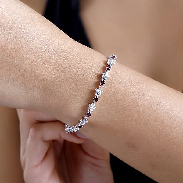 D'Joy Premium Anthill Garnet And Moissanite 6.00 Ctw Flower Bracelet In Rhodium Over Sterling Silver (8.00 In)